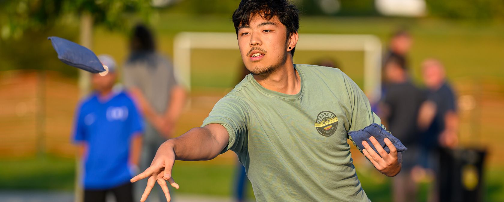 man playing cornhole
